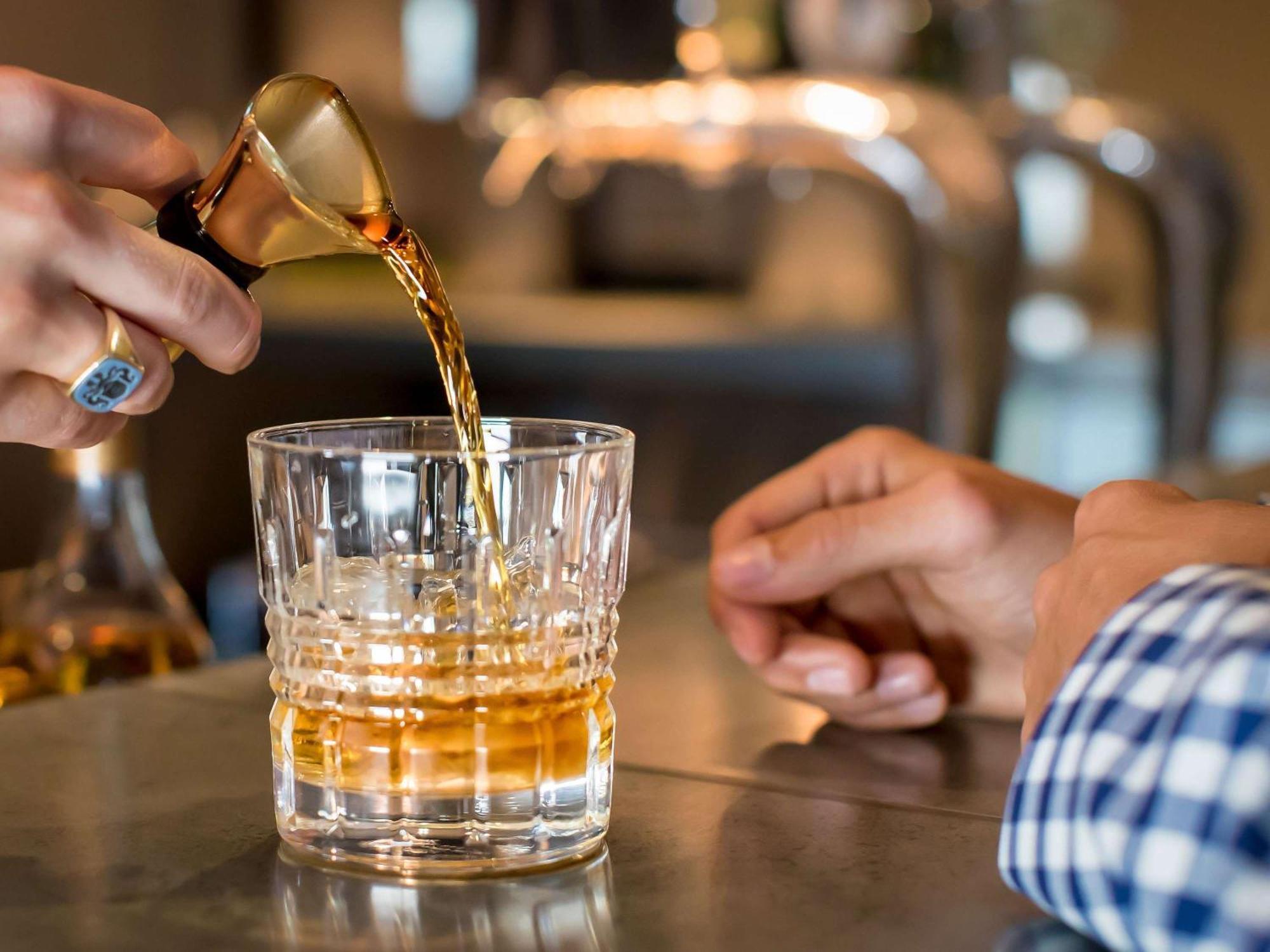The William Inglis Mgallery Уорик-Фарм Экстерьер фото A bartender pouring a glass of Old Fashioned